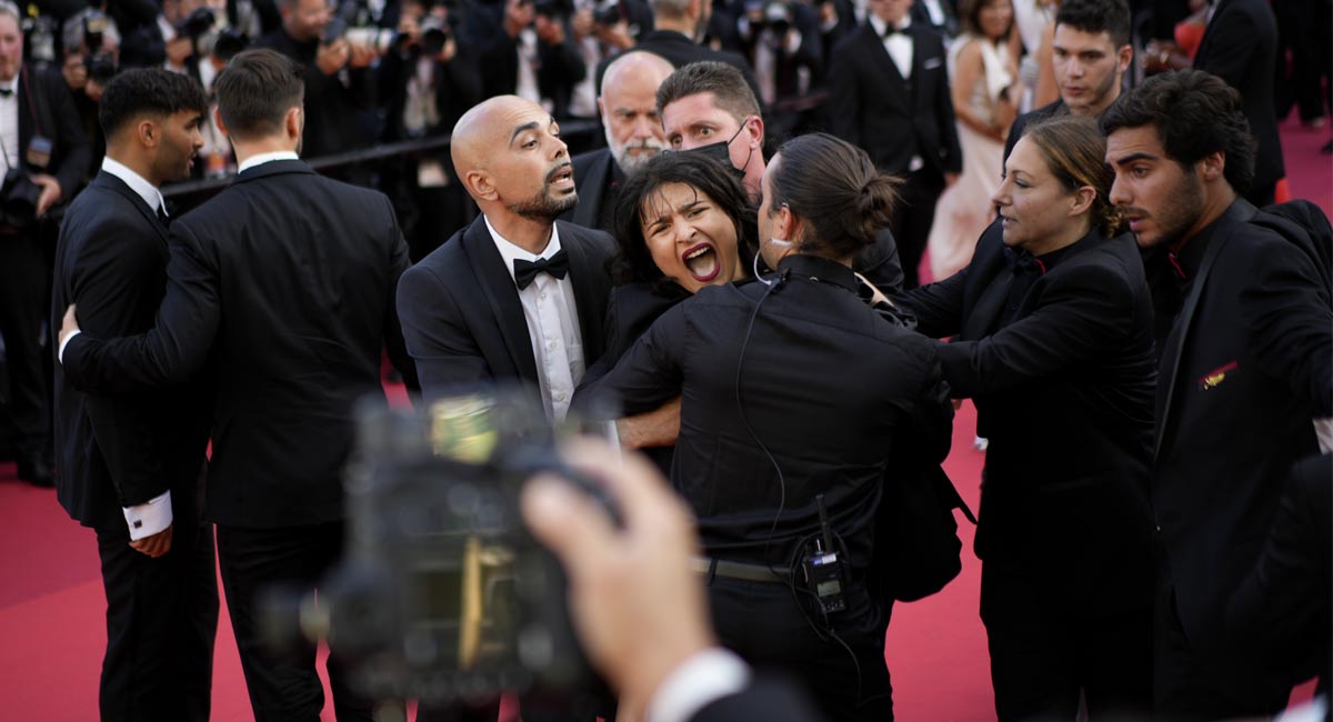 ‘Stop raping us’: Topless woman storms Cannes red carpet to protest against sexual violence in Ukraine