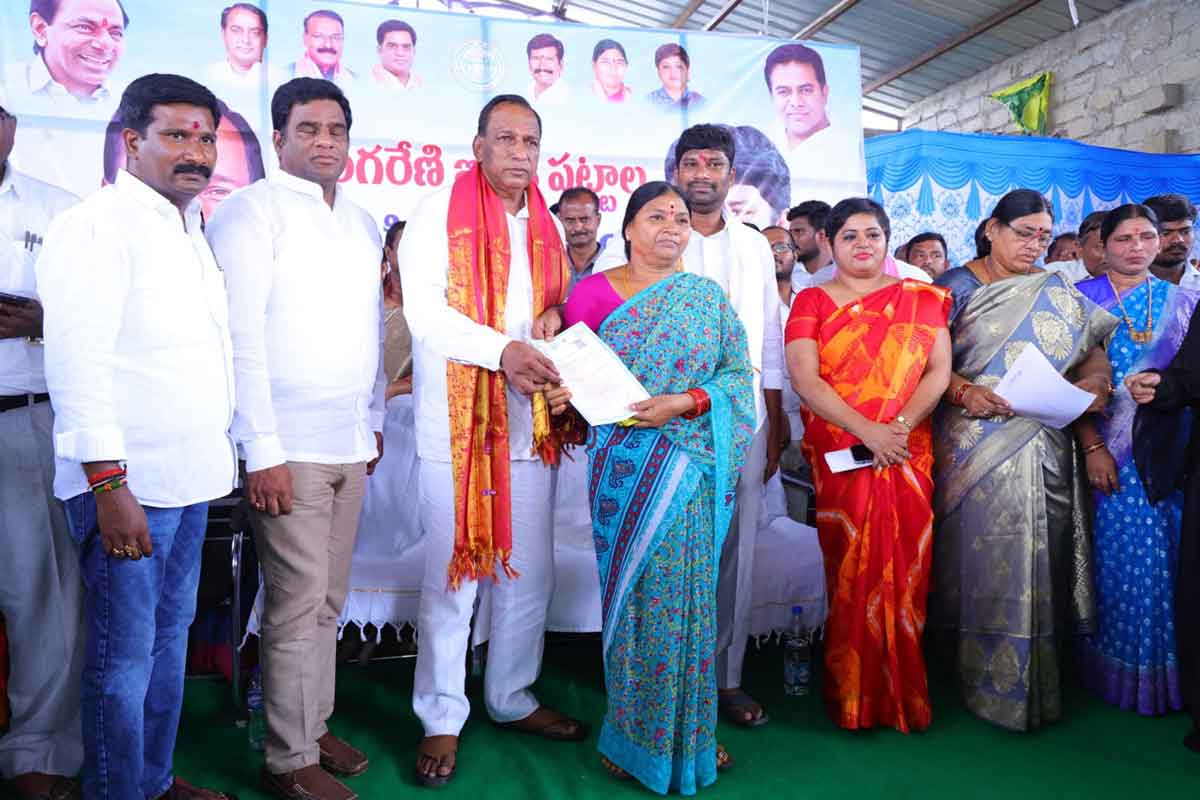 Minister Malla Reddy hands over SCCL land pattas to beneficiaries