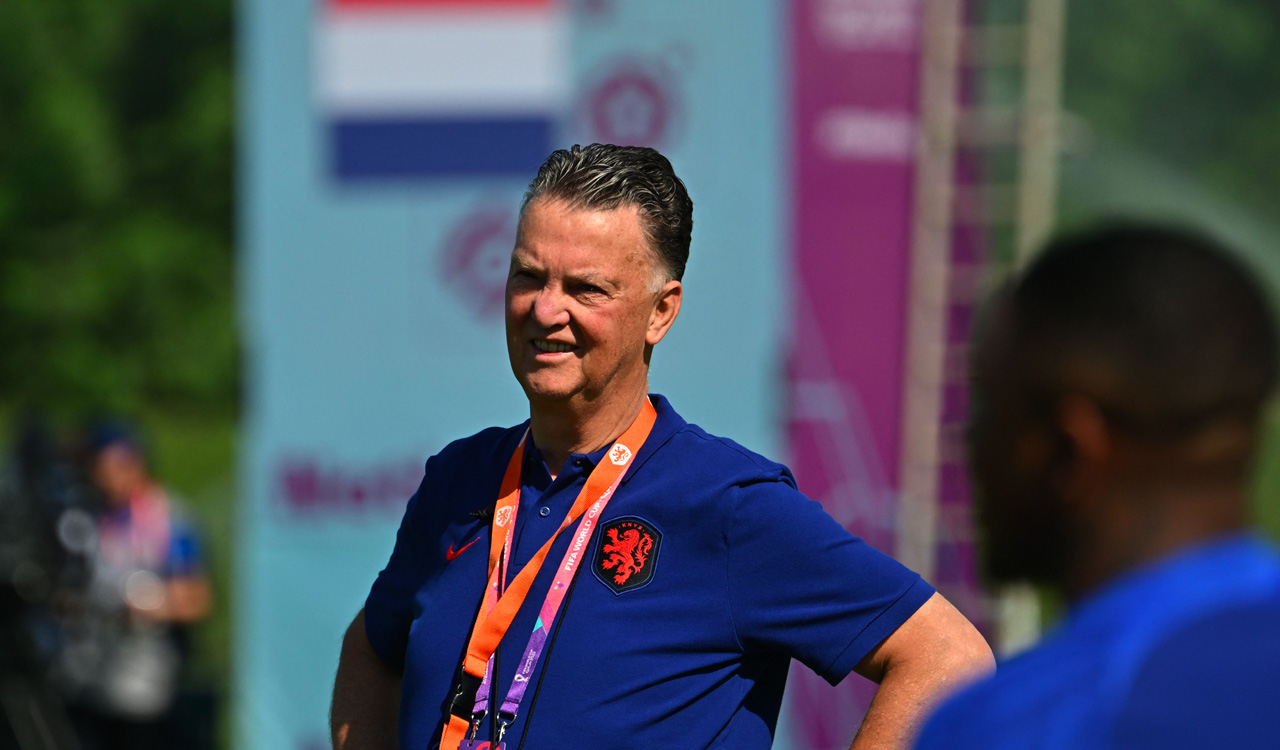 Netherlands coach Louis van Gaal hugs reporters at FIFA World Cup