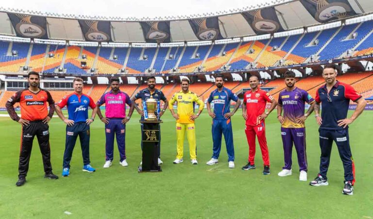 Captains of 9 IPL teams posing with the trophy