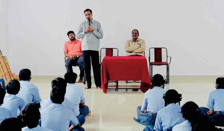 Atluri Venkata Ramana addressing students at a school