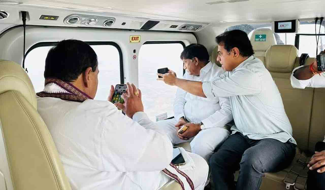 IT and Municipal Administration Minister KT Rama Rao capturing the picture of irrigation project with mobile phone from helicopter on his way to Rajanna-Sircilla on Wednesday.